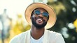© Alpa - Cool stylish black man smiling posing outdoors wearing glasses and hat