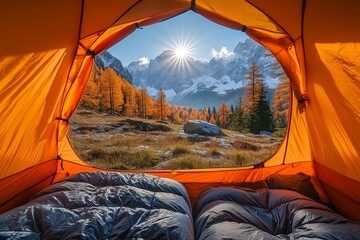 POV from a camping tent: A view from inside an orange tent, looking out at the beautiful mountain landscape with trees and a clear sky in the autumn
