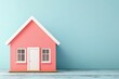 © Chananporn - A charming pink model house against a soothing blue background, perfect for home-related themes and creative projects.