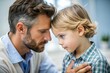 © thanakrit - Tender Moment Between Father And Son.  A Close-Up Of A Man And A Young Boy Touching Foreheads, Showing A Loving Bond.
