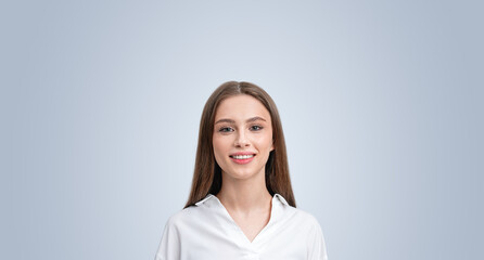 Smiling woman student on grey copy space empty background