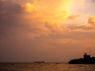 a ship is sailing in the ocean under a cloudy sky