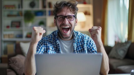 Poster - A man is sitting in front of a laptop, smiling