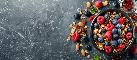 Wall Mural - Banner design featuring granola topped with berries and nuts on a grey table ideal for adding text with copy space image