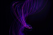 © Westend61 - Purple and blue light trails swirling against black background