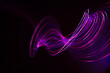 © Westend61 - Swirling light trails against dark background