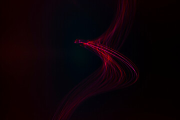 Abstract illustration of red light trails on black background