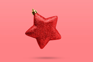 Wall Mural - Red Christmas star ornament bauble isolated on red background
