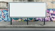 © crazyass - Urban landscape featuring an empty roadside billboard against a vibrant, graffiti-covered wall, showcasing the intersection of street art and advertising in a city setting