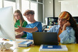 © Mediaphotos - Group of young people sitting at desk with computers during IT class in school or college in classroom
