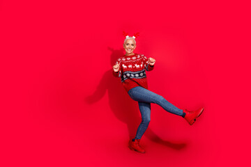 Poster - Full length photo of lovely pensioner lady deer horns dance have fun wear print sweater celebrating new year isolated red color background