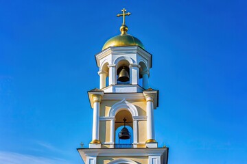 Macro shot of Orthodox memorial church bell tower against blue sky