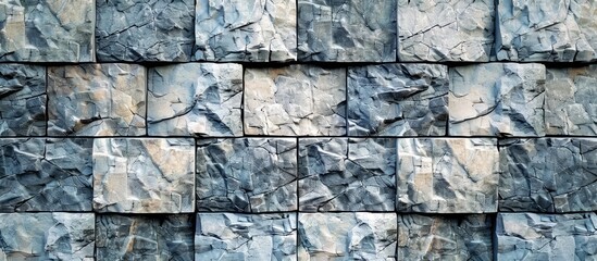 Poster - Aesthetic gray stone tiles on a massive exterior wall with a background and texture suitable for a copy space image