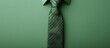 © HN Works - Top view of a fashionable necktie on a soft green backdrop with room for text in the image. Creative banner. Copyspace image