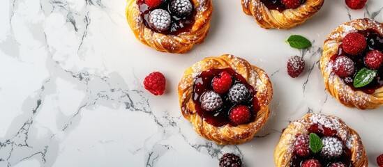 Poster - Top view of delectable berry filled puff pastries displayed on a white marble surface featuring ample copy space image