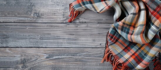 Poster - Checkered scarf on wood surface with gray background ample copy space image