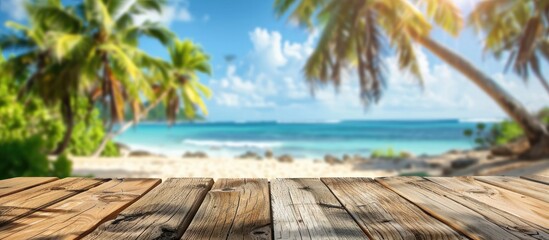 Poster - Empty wooden table in foreground against a blurry tropical beach backdrop with coconut palms ideal for showcasing summer products in a copy space image