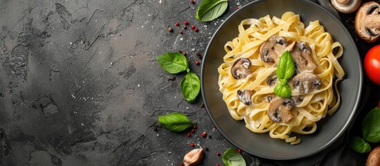 Poster - Top down view of homemade Italian pasta with champignon mushrooms and cream sauce on a rustic dark backdrop with copy space image