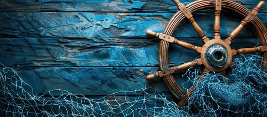Leinwandbilder - Wooden background showcasing a nautical ship wheel blue fishing net frame and ample copy space image