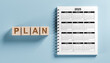 © Celt Studio - Calendar Year 2025 with plan. 2025 desk calendar notepad on blue background. New Year. plans for 2025. New Year business plan, strategies, goal, development and success.