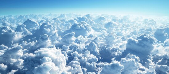 Poster - Scenic aerial view with serene white clouds against a clear blue sky visible through a plane window offering a tranquil copy space image