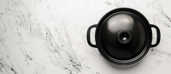 Poster - Top view of a black cooking pot with a transparent lid placed on a white marble surface offering a clear area for including text within the image. Creative banner. Copyspace image