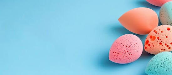 Poster - Various makeup sponges displayed on a blue background with copy space image
