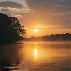 Wall Mural - A scenic sunrise over a tranquil lake, with mist rising from the water, casting a golden glow over the landscape.