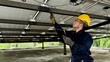 © akarapon - Technical engineer Inspecting the installation of the solar panels and checking the integrity of all wires connected to the solar panels. for the system to work properly