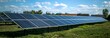 © YURII Seleznov - solar panels in field at photovoltaic power station, depicting green energy.