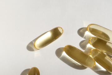 vitamin D capsules on a light background.