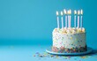 © KBL Sungkid - Birthday cake with candles and confetti on a blue background
