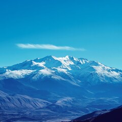 Sticker - A snow-capped mountain range with a blue sky and a wisp of cloud above.