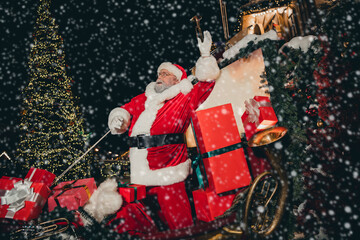 Wall Mural - Photo of old bearded person man wear red costume in sleigh pulled reindeer start trip travel illuminated streets magic time outdoors