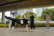 © DragonImages - Breakdancer performing intricate moves under urban bridge while onlookers watch attentively Adding dynamic energy to vibrant cityscape