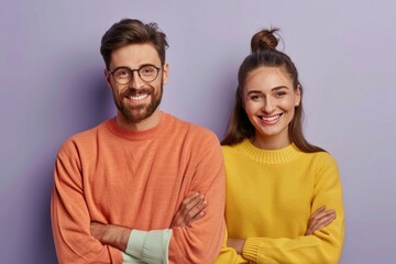 Cheerful couple cuddling  showing copy space  isolated on grey.