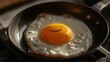 © Sompoch - Fried egg in a pan with a smiling face created on the yolk.