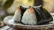 © bephoto - 焼きおにぎりと陶器の皿