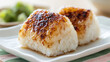© bephoto - 焼きおにぎりと陶器の皿