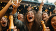 © Sergey - A group of young people celebrating, raising champagne glasses in the air surrounded by confetti with joyful expressions and golden lights in the background.