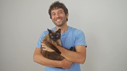 Sticker - Young hispanic man cuddling his siamese cat against an isolated white background, creating a heartwarming scene showcasing their bond and affection.