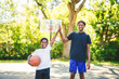 © Louis-Paul Photo - portrait of brother playing with a basketball in park