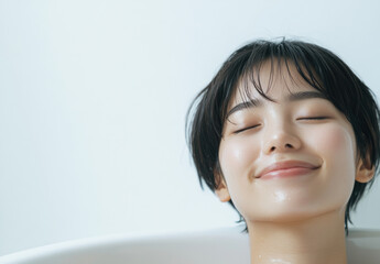 Poster - A Japanese woman is relaxing in the bathtub, her eyes closed and she's smiling as if enjoying herself.