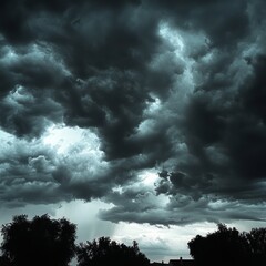 Wall Mural - Dramatic stormy sky with dark clouds and a glimpse of sunlight through the clouds.