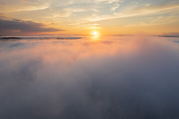 Aerial landscape over the clouds, at sunrise