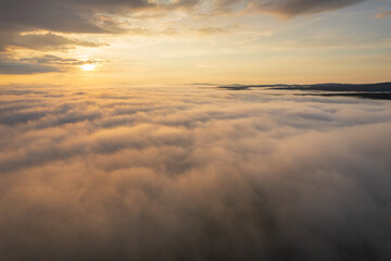 Aerial landscape over the clouds, at sunrise