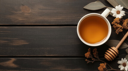 Poster - Top view of a mug of herbal tea on a dark wooden table, adorned with dried flowers, leaves, and a wooden honey dipper. Natural and cozy setting.