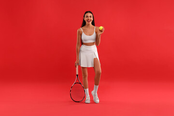 Sticker - Beautiful young woman with tennis racket and ball on red background