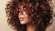 © arthit - Close-up of a woman with curly hair styled in defined, bouncy curls, set against a plain backdrop to highlight the volume and natural texture.