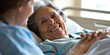 © kwanchaift - Elderly patient receiving compassionate care from a nurse in a nursing home environment